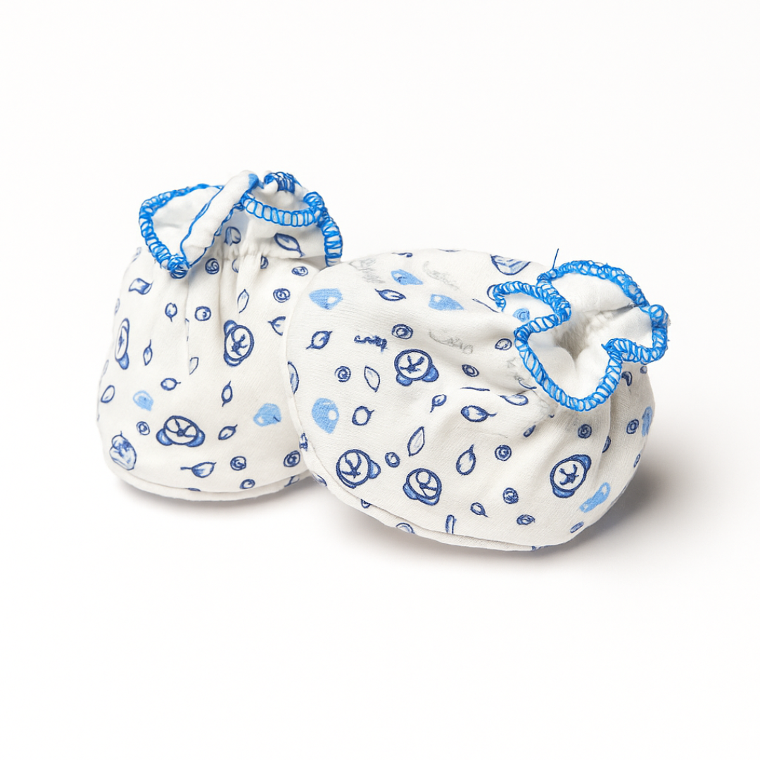 Pair of baby booties with blue patterns on a white background