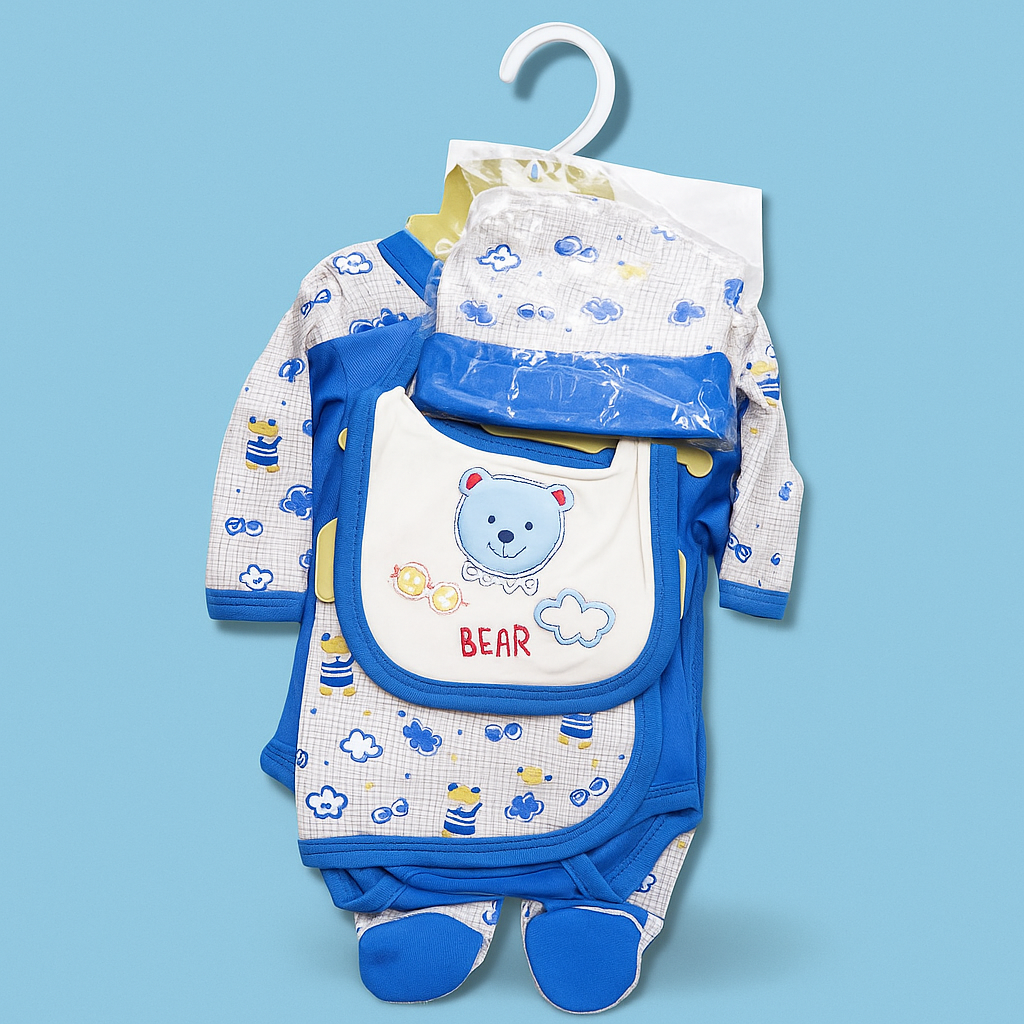 Baby clothing set with bib, pants, and booties on a hanger against a blue background