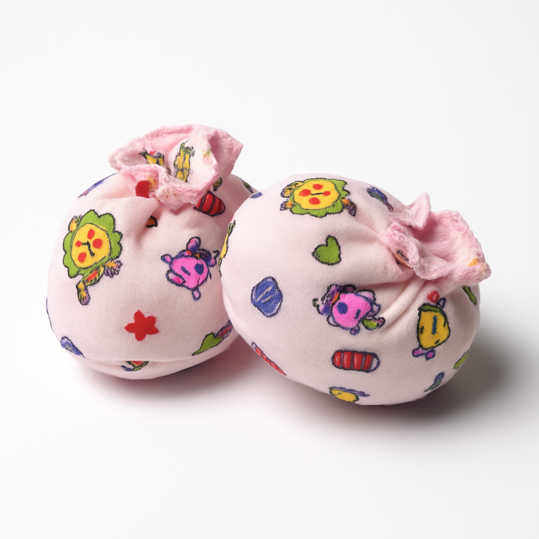 Two pink booties with colorful cartoon designs 