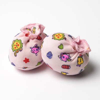 Two pink booties with colorful cartoon designs 