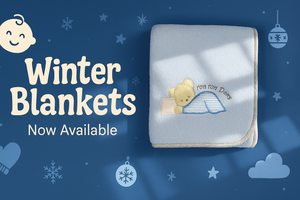 Baby blanket with teddy bear design on a blue background with text 'Winter Blankets Now Available'.