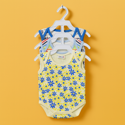 Yellow baby romper with blue floral pattern on a hanger against an orange background